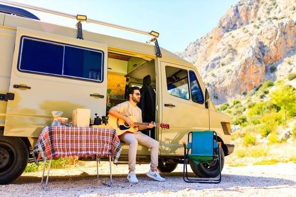 young indian man vacation travel RV, holiday trip in motorhome in mountain