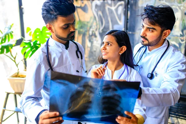 indian doctors are checking examining chest x-ray film