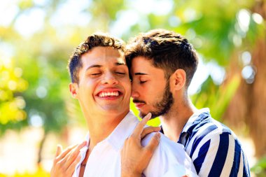 young same sex couple in love outdoors together showing all of feels clipart