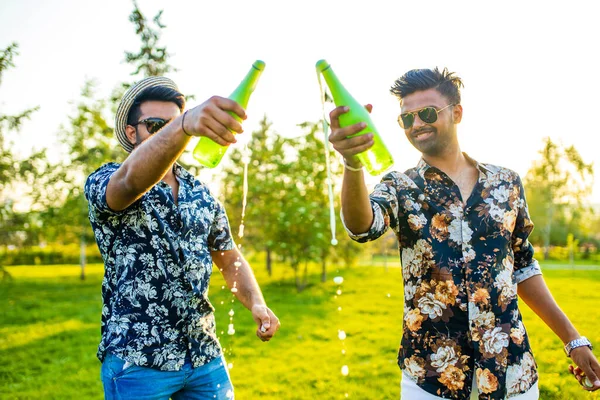 pakistanian happy best friends partying with lemonade in summer park.