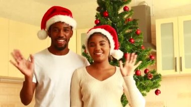 Latin çift evdeki Noel ağacının yanında ailesiyle konuşuyor..