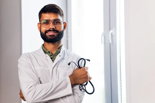 indian pet doctor wearing uniform and holding a stethoscope.