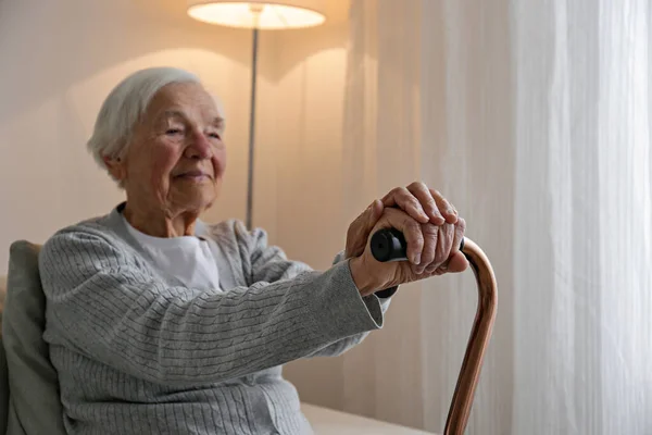 Portrait Senior Female Sitting Couch Home Leaning Cane Elderly Woman — Fotografia de Stock