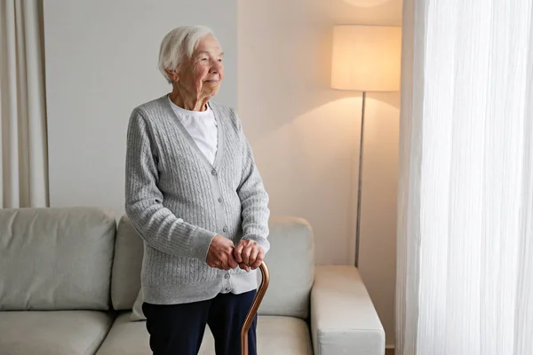 Senior Woman Years Age Standing Window Walking Cane Her Apartment — Fotografia de Stock