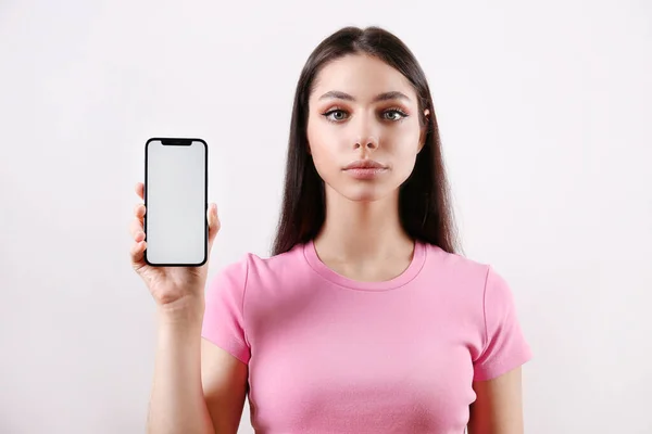 Portrait Young Woman Serious Facial Expression Showing Phone Blank Screen — Stock Fotó