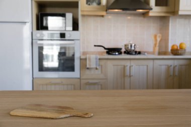 Stylish wooden kitchen with built-in appliances and small beige tile. Close up, copy space, background.