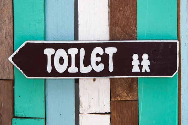 Sign restroom of men and women on wood background — Stock Photo, Image