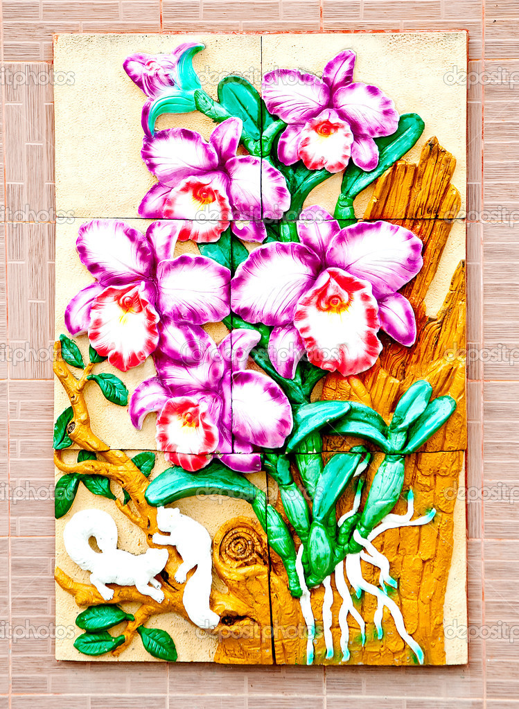 The Carving ceramic of orchid on wall background