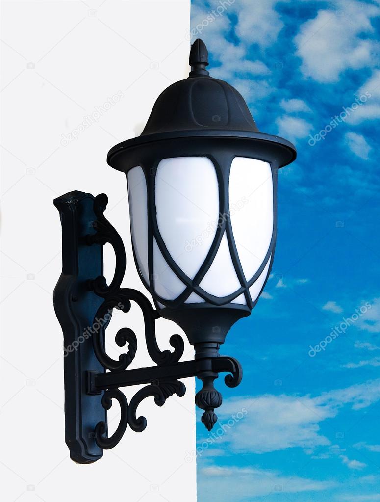 Old lamp on blue sky background