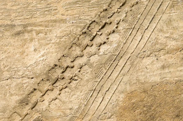 Motorcycle tire tracks on soil floor — Stock Photo, Image