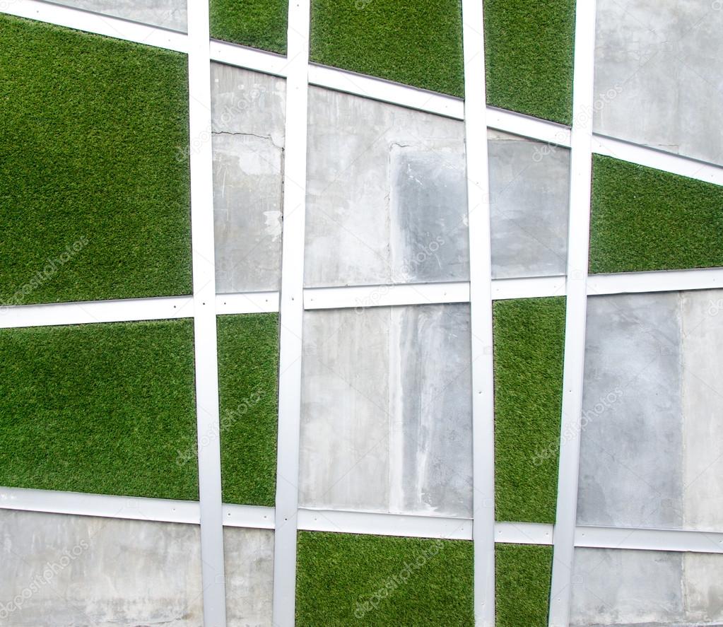 Cement wall with artificial grass background