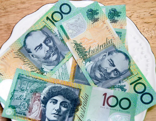 Colorful of Australian Currency on white plate on wood table — Stock Photo, Image