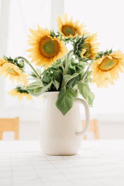 Sunflowers bouquet in vase on the table