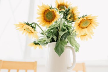 Sunflowers bouquet in vase on the table