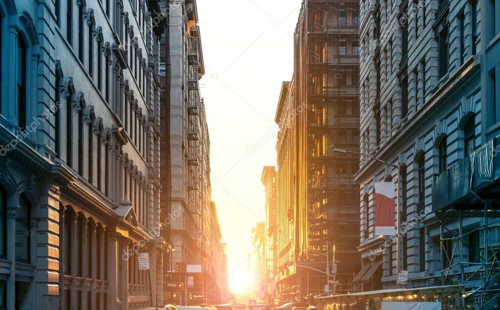 Colorful light of summer sunset shining through the buildings along 19th Street in Midtown Manhattan in New York City