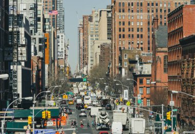 Overhead view of a busy street scene with people and traffic traveling through Manhattan in New York City NYC