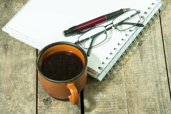 Cup of coffee with notebook — Stok fotoğraf