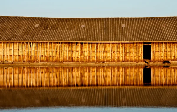 Отражение деревянного дома в воде — стоковое фото