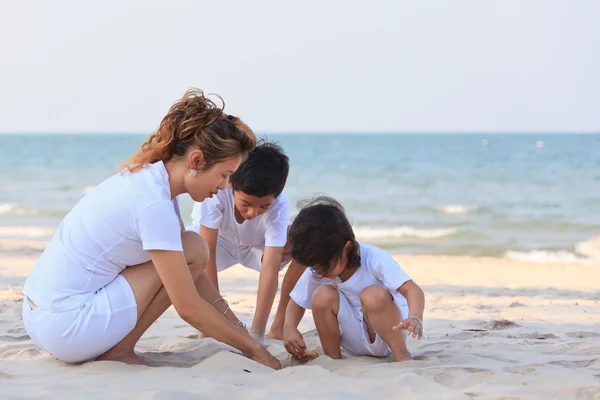 Asian family play sand on beach — Stock Photo, Image
