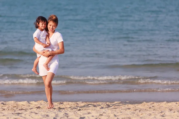 Asian woman hold the boy on beach — Stock Photo, Image