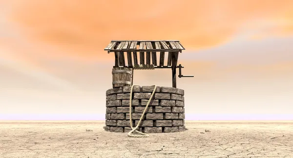 Wishing Well With Wooden Bucket On A Barren Landscape — Stock Photo, Image