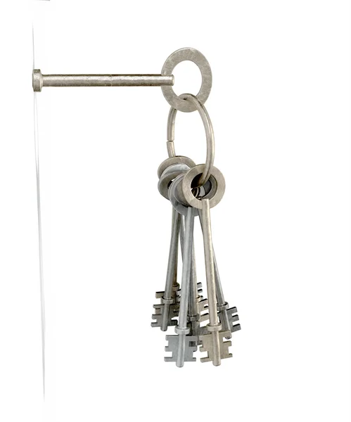 Ключи, вставленные в белую стену — стоковое фото