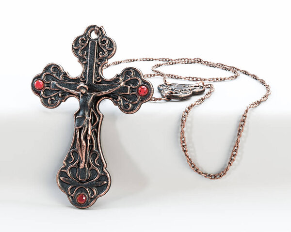 A closeup of an ornate brass antique rosary chain necklace with a crucifix draped on an isolated white background - 3D render