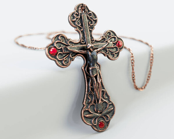 A closeup of an ornate brass antique rosary chain necklace with a crucifix draped on an isolated white background - 3D render