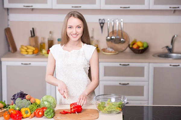 Smiling woman cooking in kitchen