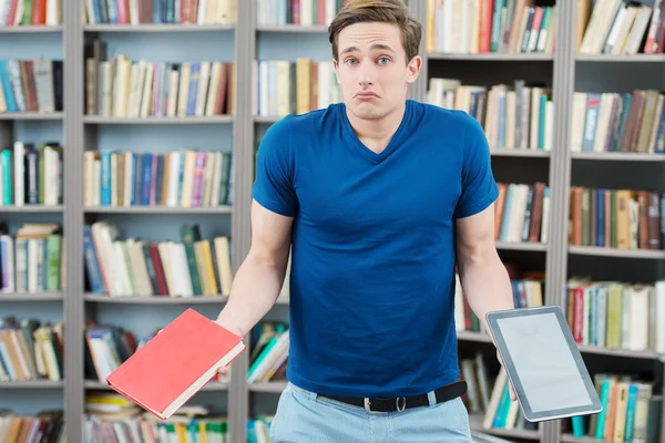 Confused student trying to choose between book and computer