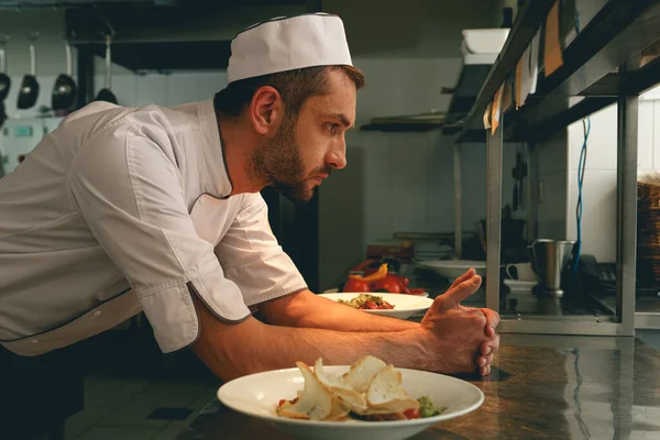 Tired chef on kitchen restaurant waiting for a new order. High quality photo