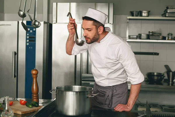 Gastronomy expert checking food taste before send it to customers in restaurant