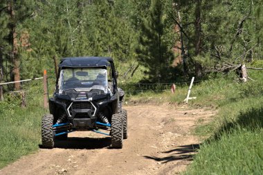 Side-by-Side ATV after passing thru a gate on a National Forest trail