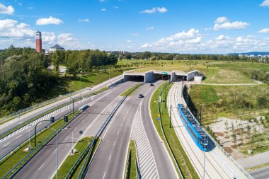 New city highway in Krakow, Poland, called Trasa Lagiewnicka with separate tunnels for cars and tramway with traffic and tram.  Part of the ring road around the city center. John Paul II Sanctuary