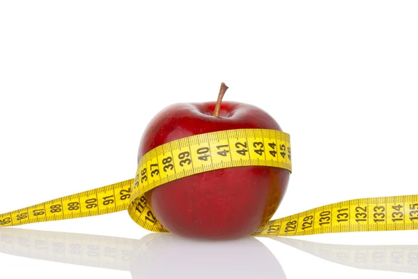 Red apple with measure tape — Stock Photo, Image