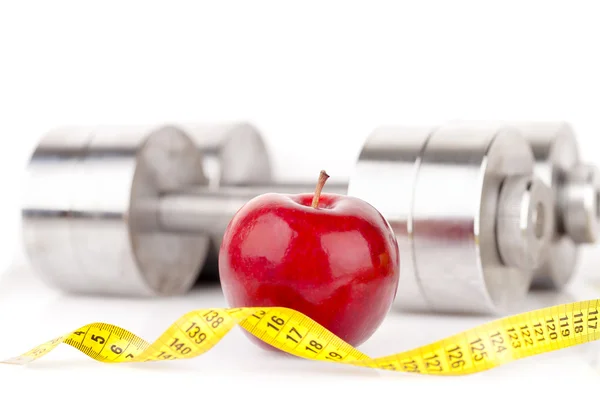 Dumbbell and an apple — Stock Photo, Image