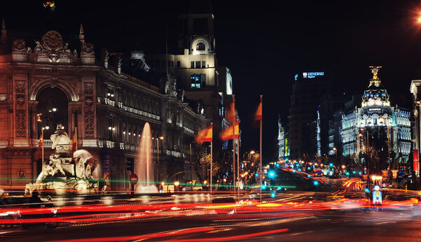 MADRID - APRIL 11, 2013: View of Gran Via street with cars at night. Famous building Metropolis - an office building and a symbol of the modern city