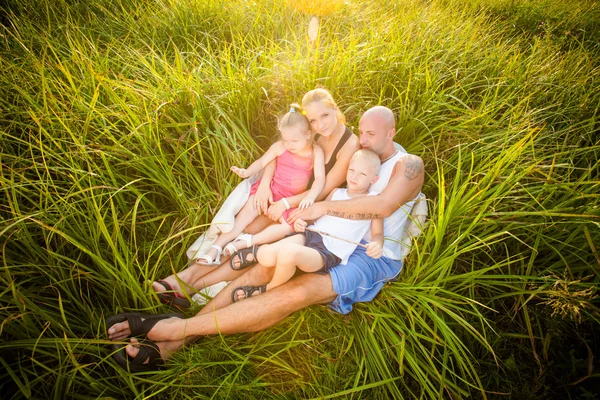 Happy family in a park — Stock Photo, Image