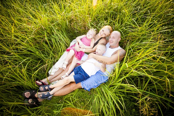 Happy family in a park — Stock Photo, Image