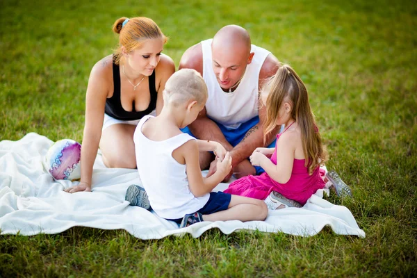 Happy family in a park — Stock Photo, Image