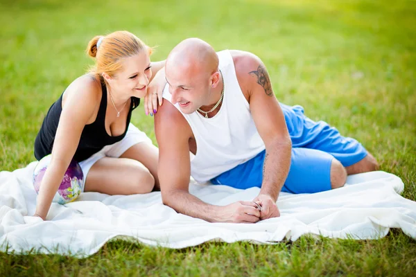 Happy young adults couple in a park — Stock Photo, Image