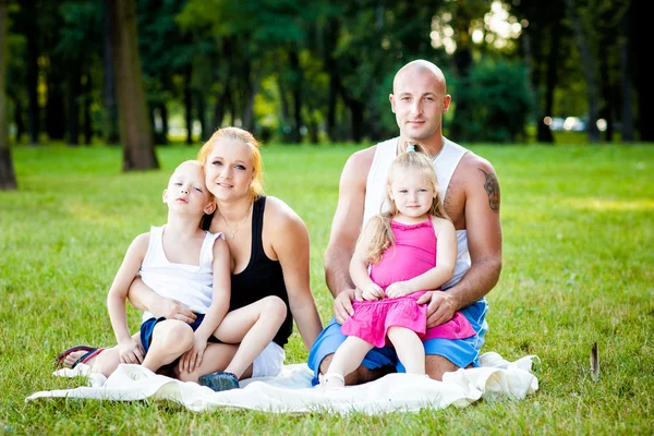 Happy family in a park — Stock Photo, Image