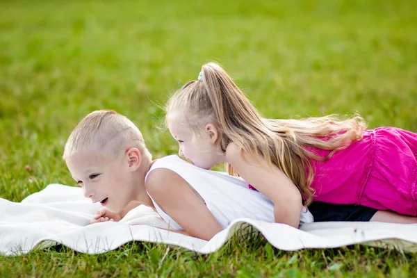 Happy little girl and boy in a park — Stock Photo, Image