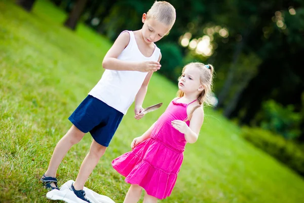 Little boy and girl with ladybird in park — Stock Photo, Image