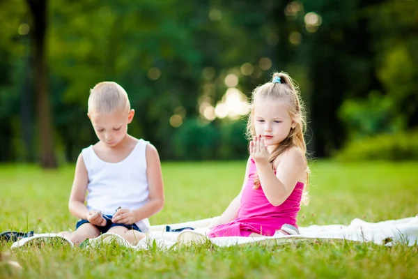 Little boy and girl with ladybird in park — Stock Photo, Image