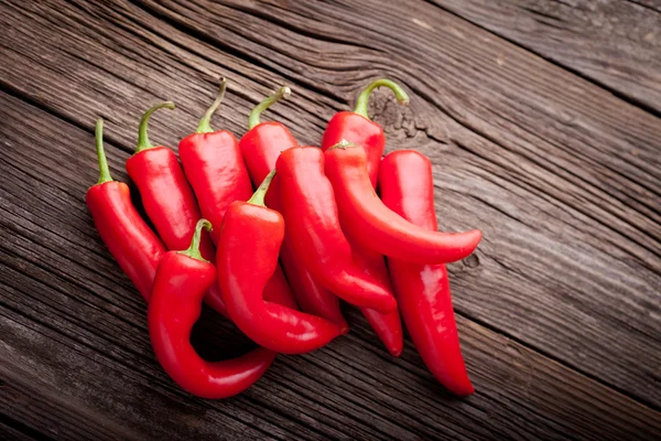 Färsk röd chili på ett träbord — Stockfoto