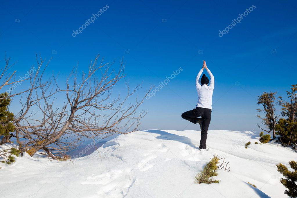 Winter yoga session in beautiful mountain place