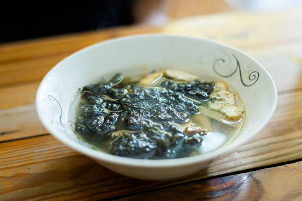 Delicious colorful local food in vegan restaurant - wakame watercress soup. Traditional vietnamese cuisine in Ho Chi Minh, Vietnam.