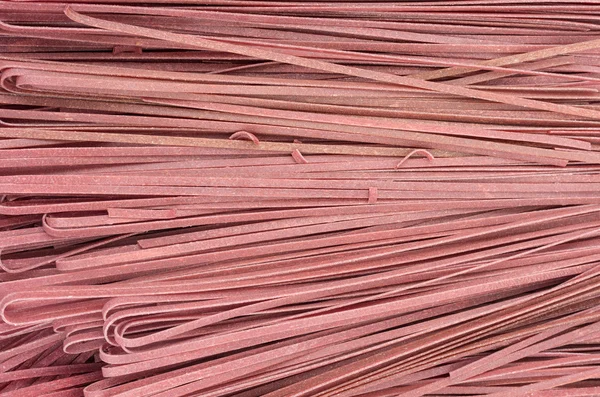 Fresh pasta with red color on display — Stock Photo, Image