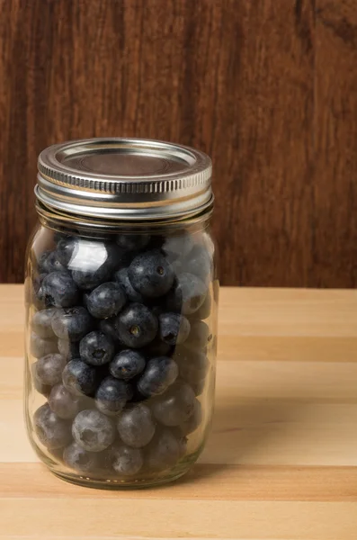 Jar of fresh blueberries on table — Stock Photo, Image